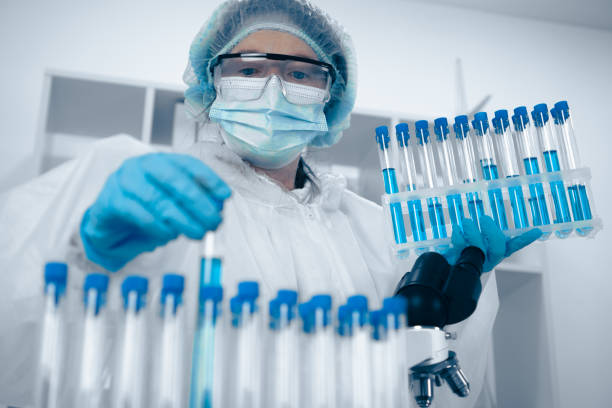 Technician carefully handling biological samples for clinical-trial logistics